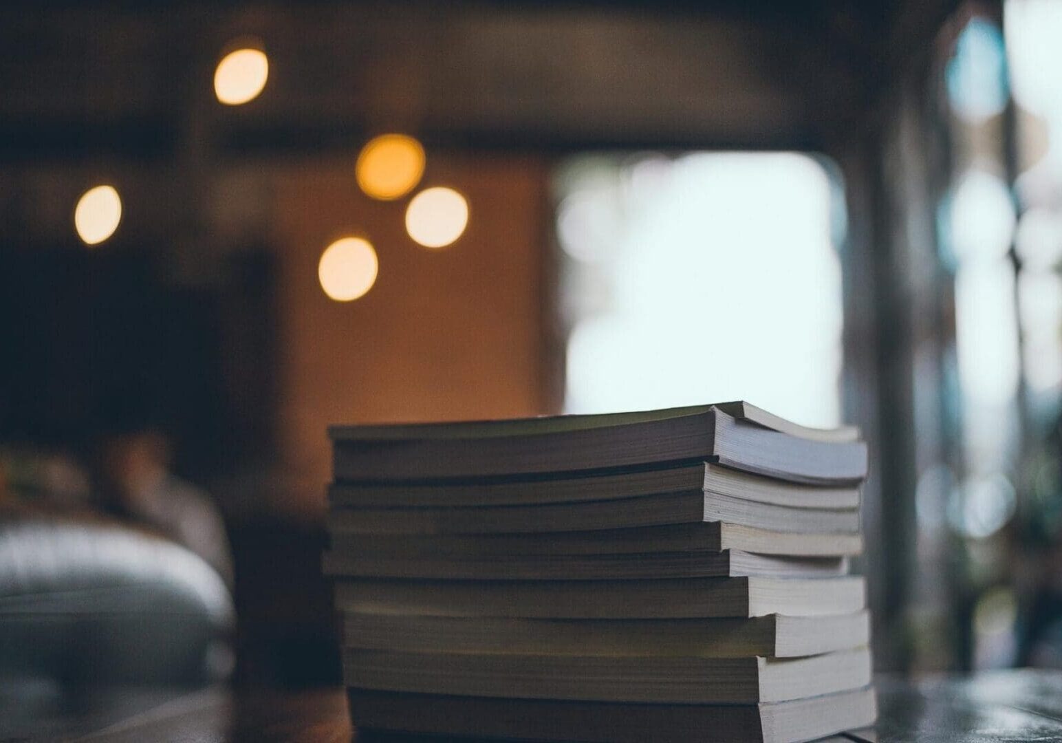 Stack of books with blurred bokeh lights
