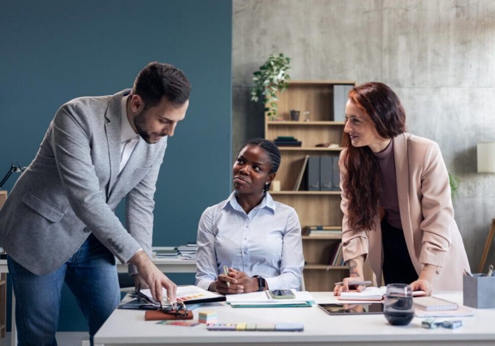 Diverse business team collaborating and analyzing documents during an office meeting