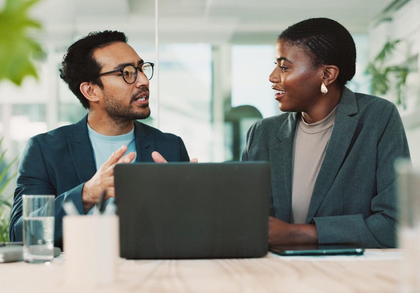 Office, partnership and team advice for laptop, proposal and research notes with document for report. Man, woman and feedback for small business, collaboration and meeting for training or b2b project