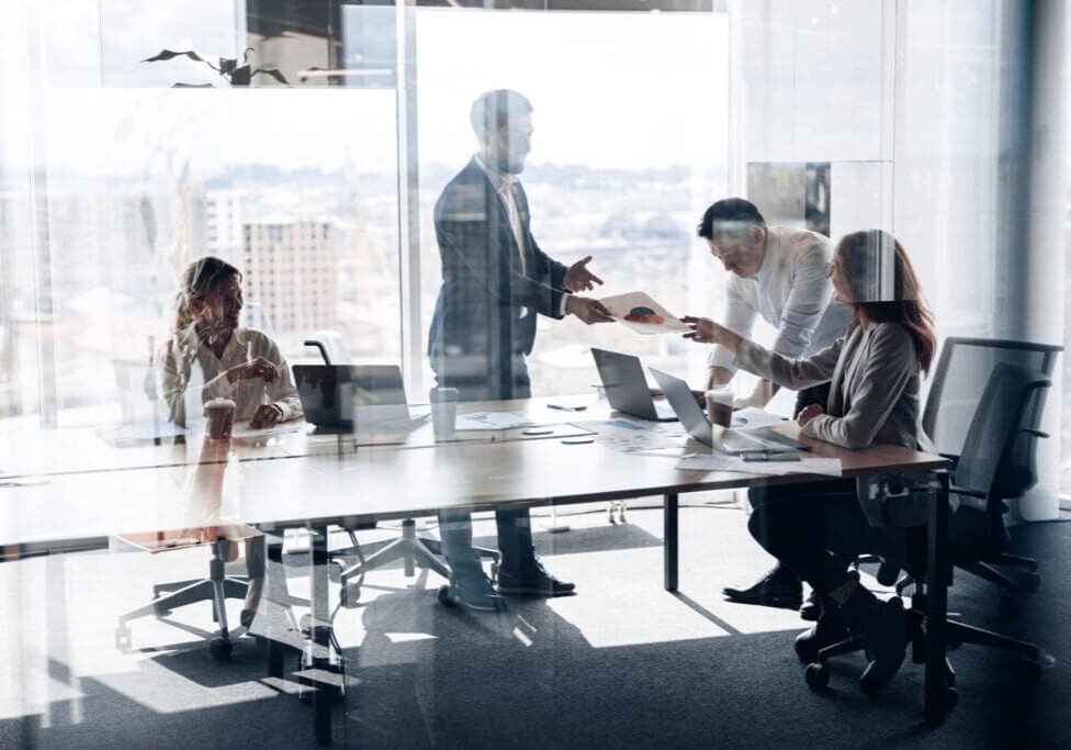 Creative business people working on project in modern office with panoramic view. Teamwork concept