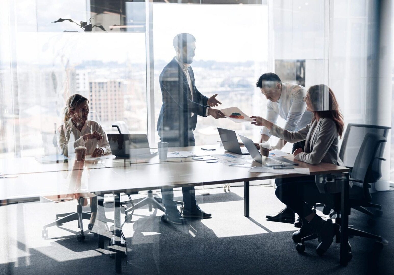 Creative business people working on project in modern office with panoramic view. Teamwork concept