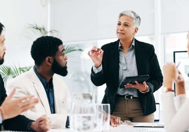 Presentation, coaching and meeting with business woman and tablet for research, training and project management. Idea, strategy and data analysis with ceo and people in office for brainstorming chart