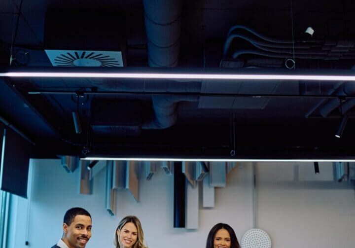 Group of happy business professionals posing in an office, showcasing teamwork, collaboration, and success