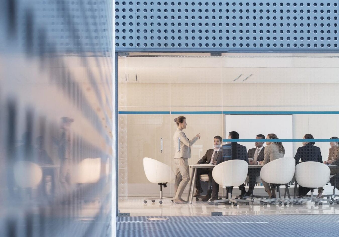 Businesswoman leading meeting in modern conference room