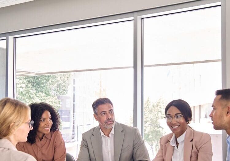 Busy international professional executive business team diverse colleagues employees work group talking consulting planning project, having discussion at office corporate board room meeting. Vertical