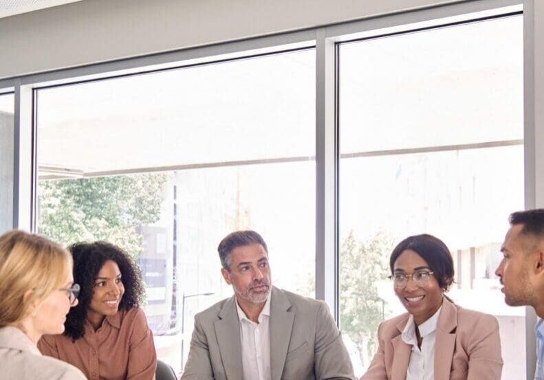 Busy international professional executive business team diverse colleagues employees work group talking consulting planning project, having discussion at office corporate board room meeting. Vertical