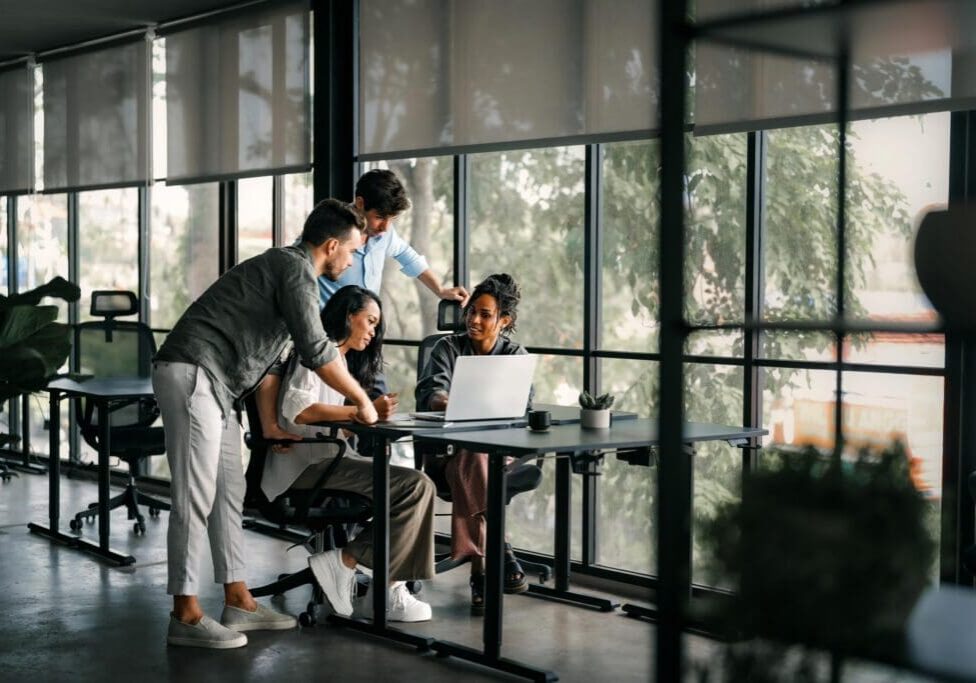 A diverse, talented team collaborates effectively in a bright office space during a business meeting. Creative group of successful coworkers working together