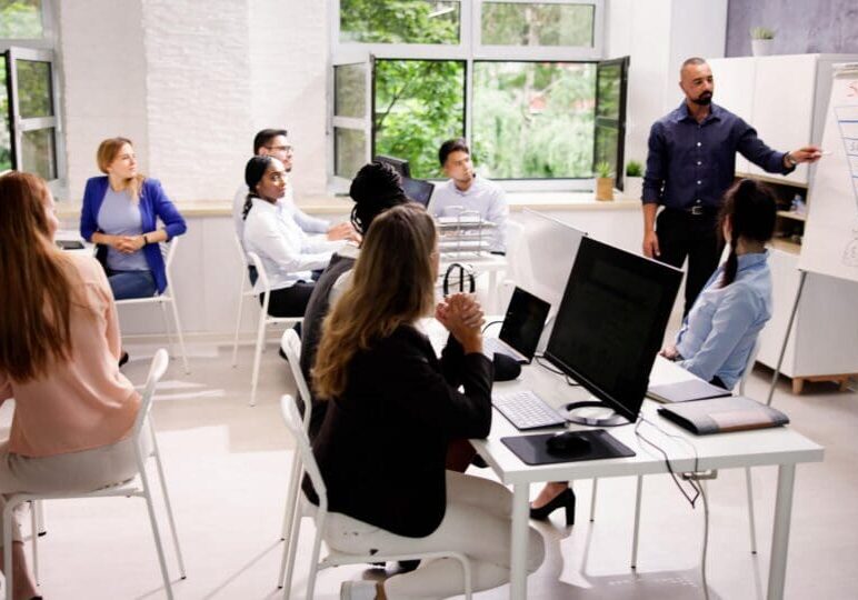 Corporate Training Presentation In Classroom With Computers