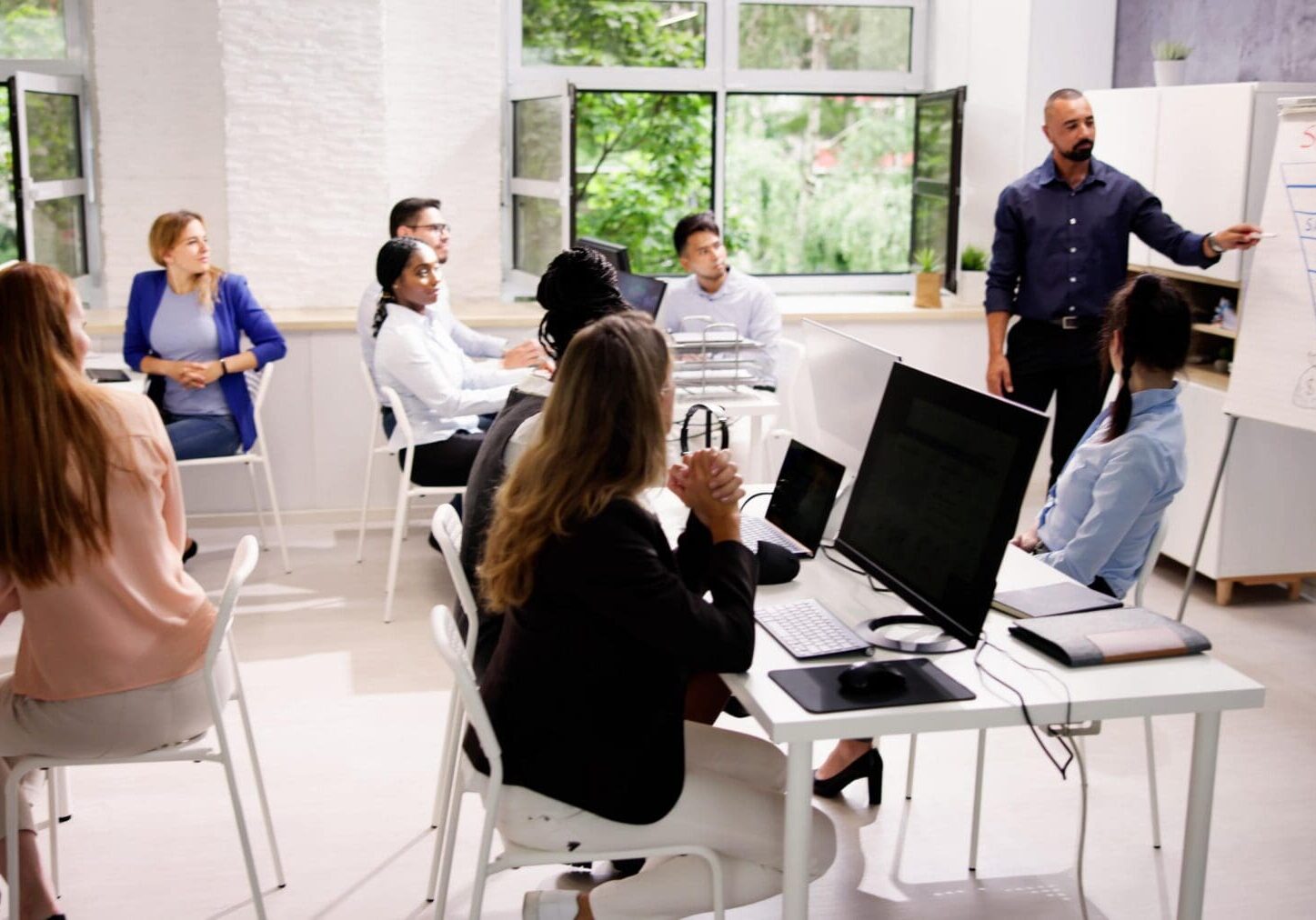 Corporate Training Presentation In Classroom With Computers