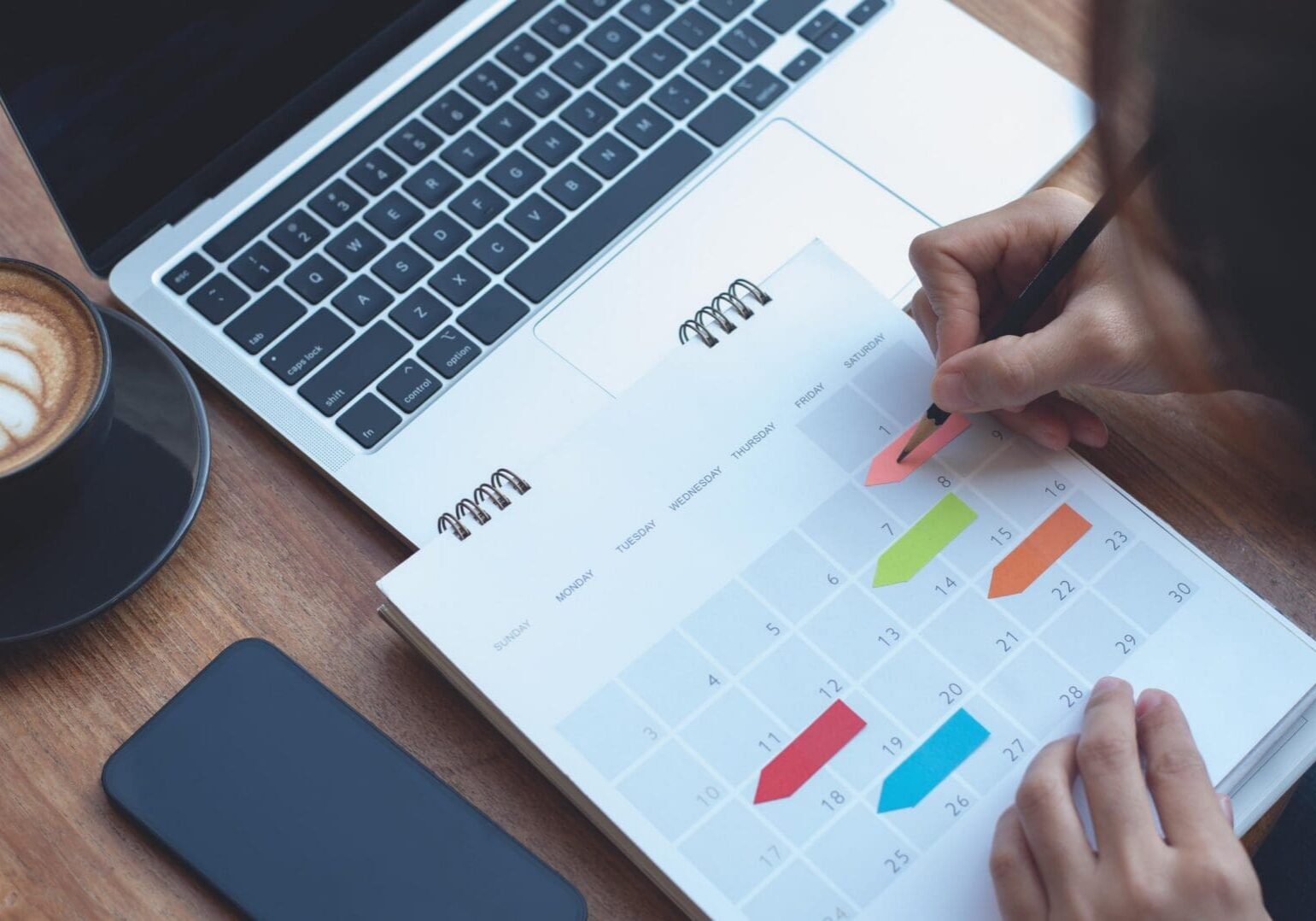 2024 Event planner timetable agenda plan on schedule event. Business woman checking planner, taking note on calendar desk on office table. Calendar event plan, work planning