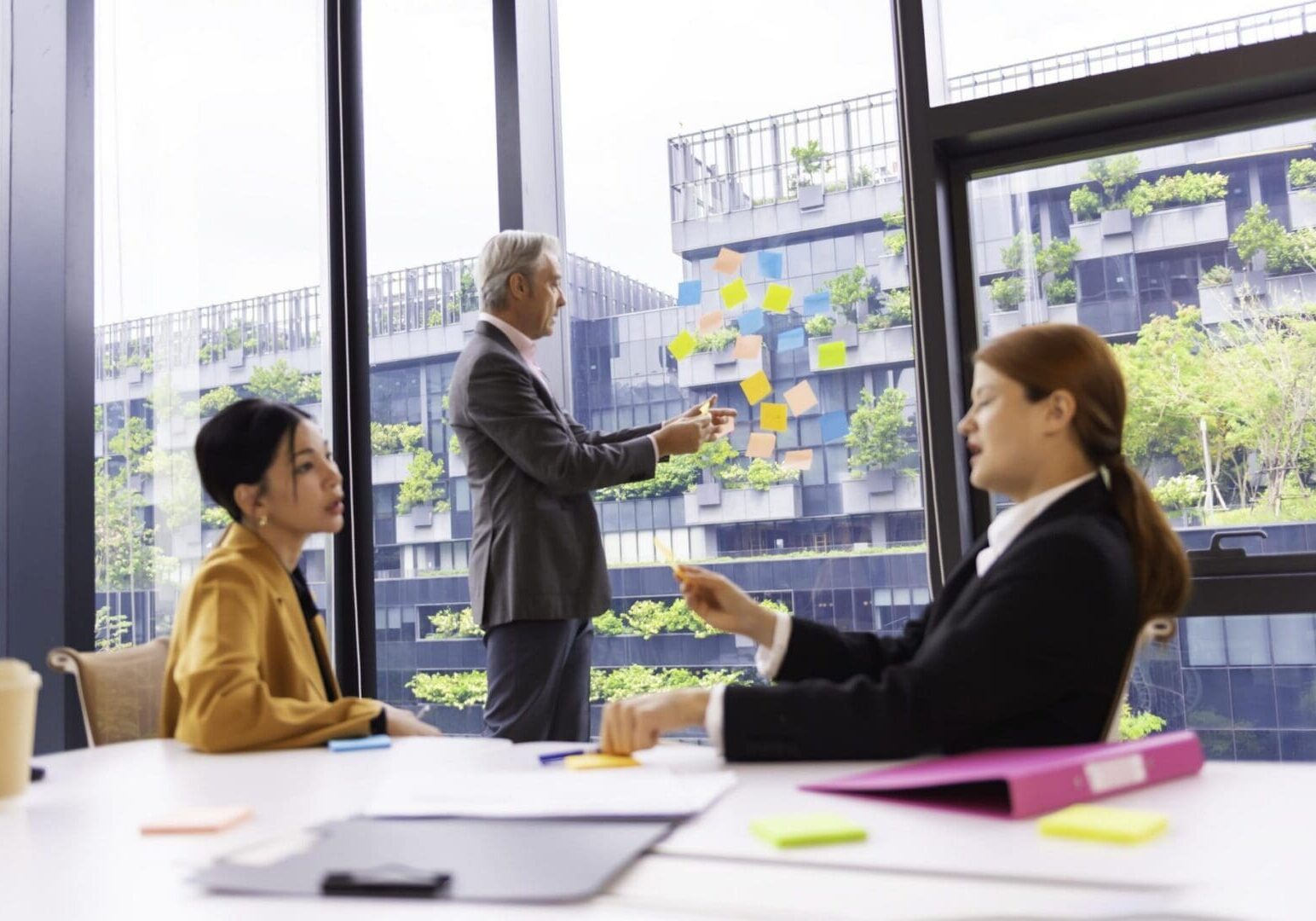 Business team in a creative meeting, collaborating and sharing ideas using colorful notes on a glass wall. A modern teamwork setting showing brainstorming, innovation, and planning in office
.teamwork concepts.