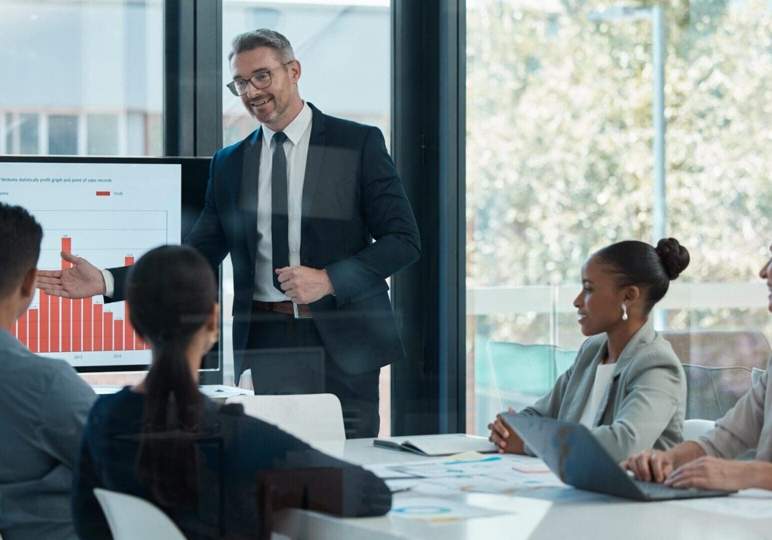 Meeting, training and planning with a CEO, manager or leader and his team in the boardroom. Collaboration, workshop and presentation with a business man and staff talking about vision and mission
