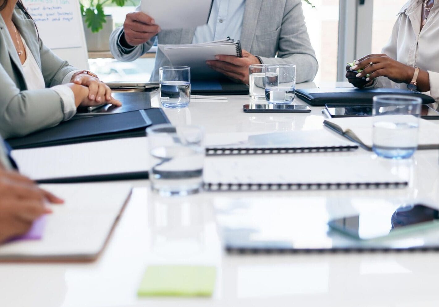 Hands, documents and hands of business people in office meeting for financial, review or budget analysis. Corporate, collaboration and accounting team coworking on paper, data or research statistics